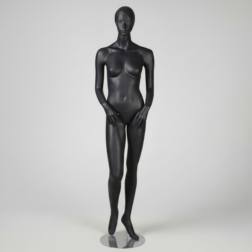 Dömugína - 1400. Mattgrá með höfði, andlitsdráttum og mótuðu hári. Hæð 178 cm. Hendur fyrir framan líkama.
